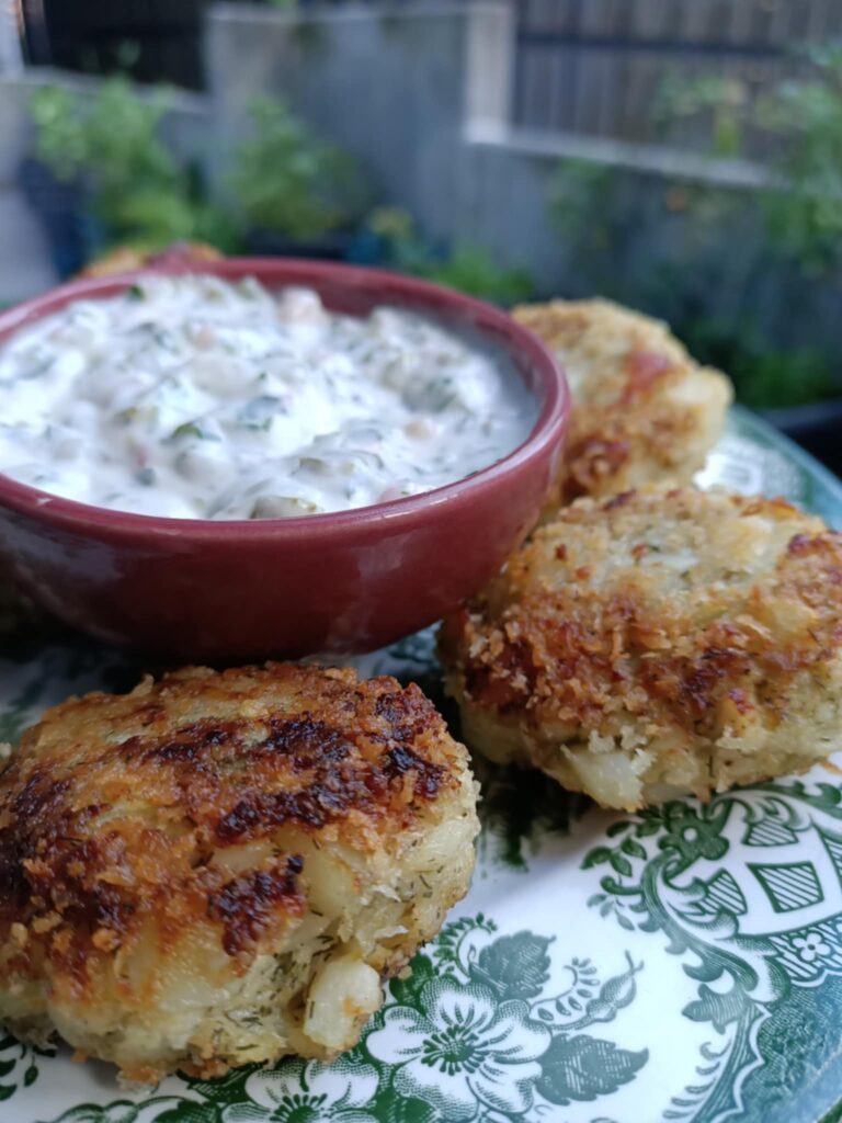 photo of fishcakes and tartar sauce on a green plate