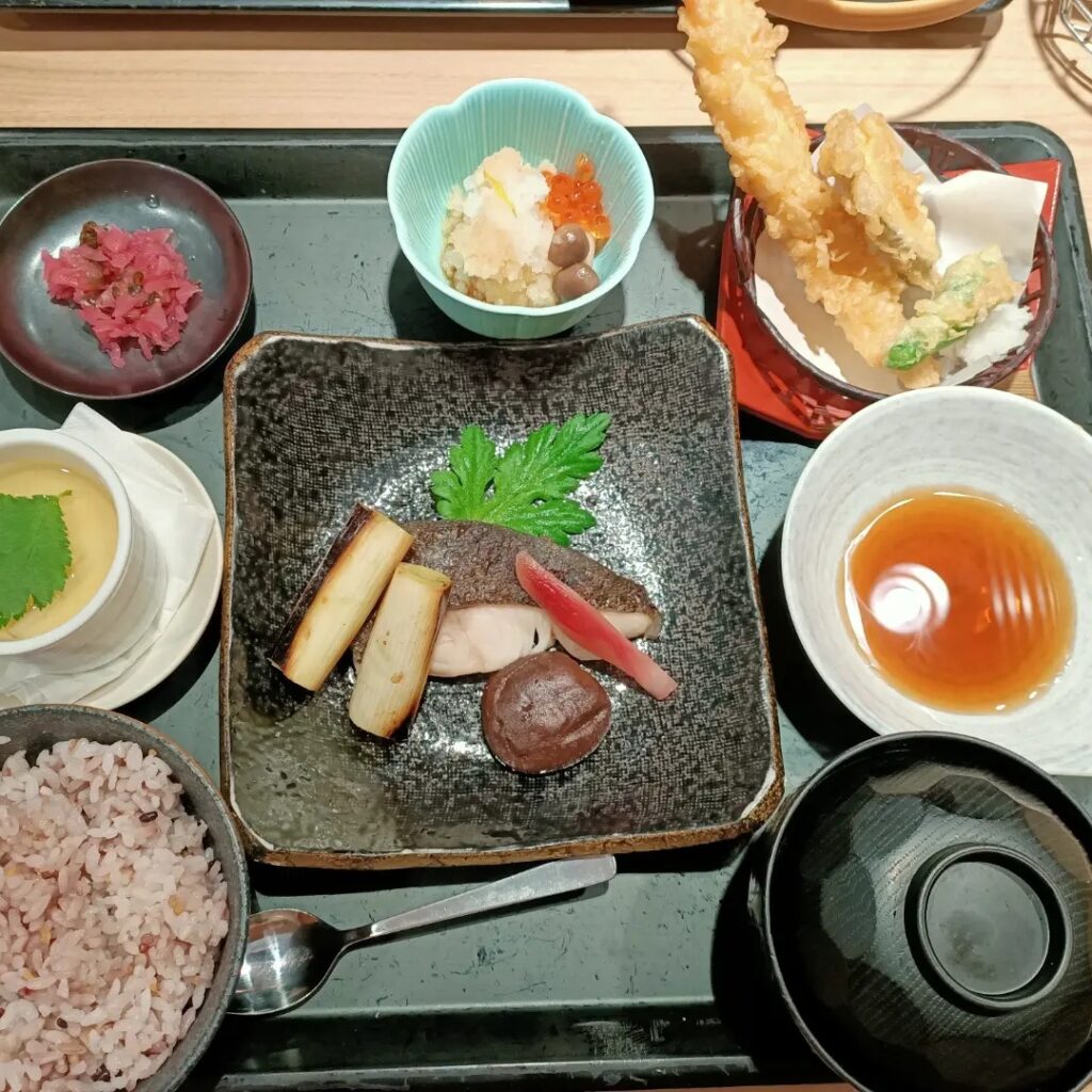 photo of a tray of food in little bowls and plates