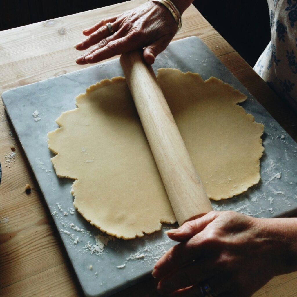 photo of someone rolling out pastry dough