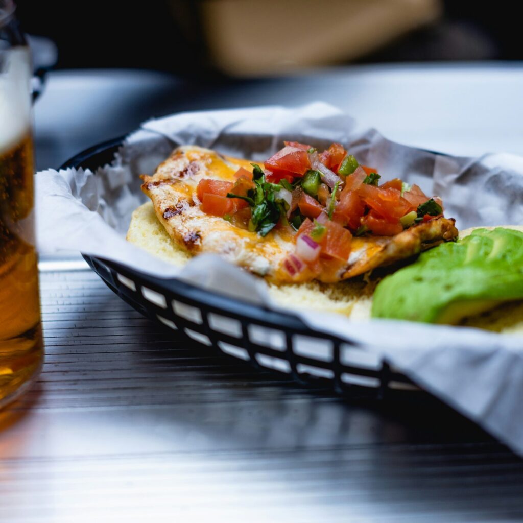 photo of a close up of a taco and salsa in a plastic basket