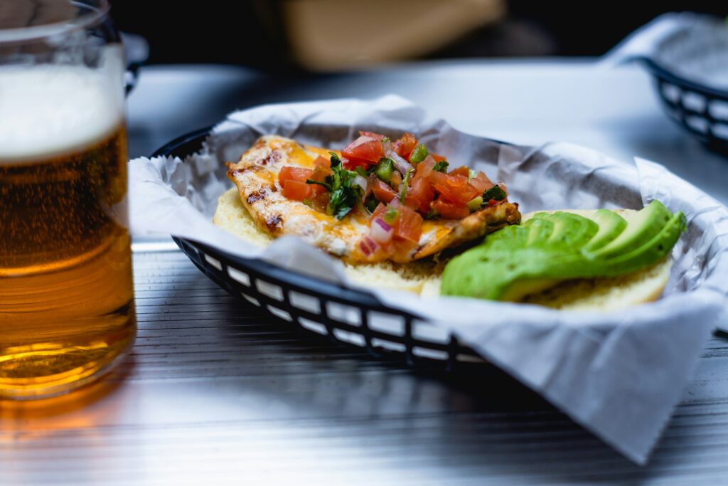 photo of a basket with some tacos topped with salsa