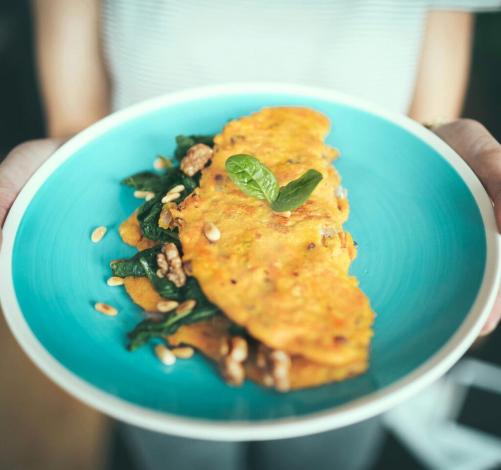 photo of an omelette on a blue plate