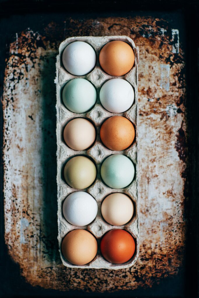 photo of a dozen eggs in shades of brown and light blue