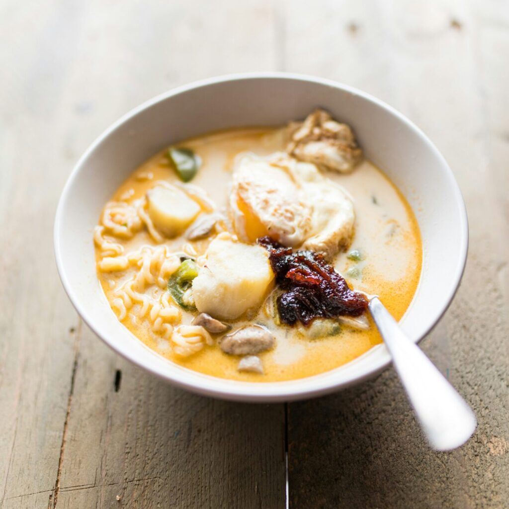 photo of a bowl of soup on a wooden table