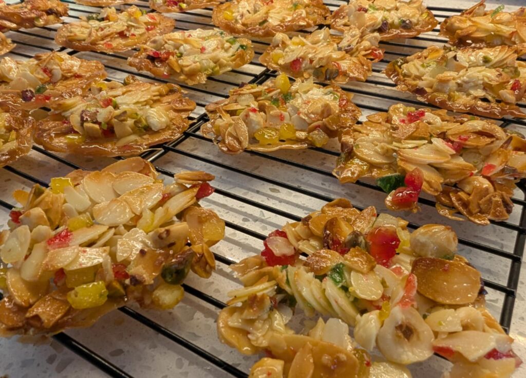 golden brown nut biscuits ona black cooling rack