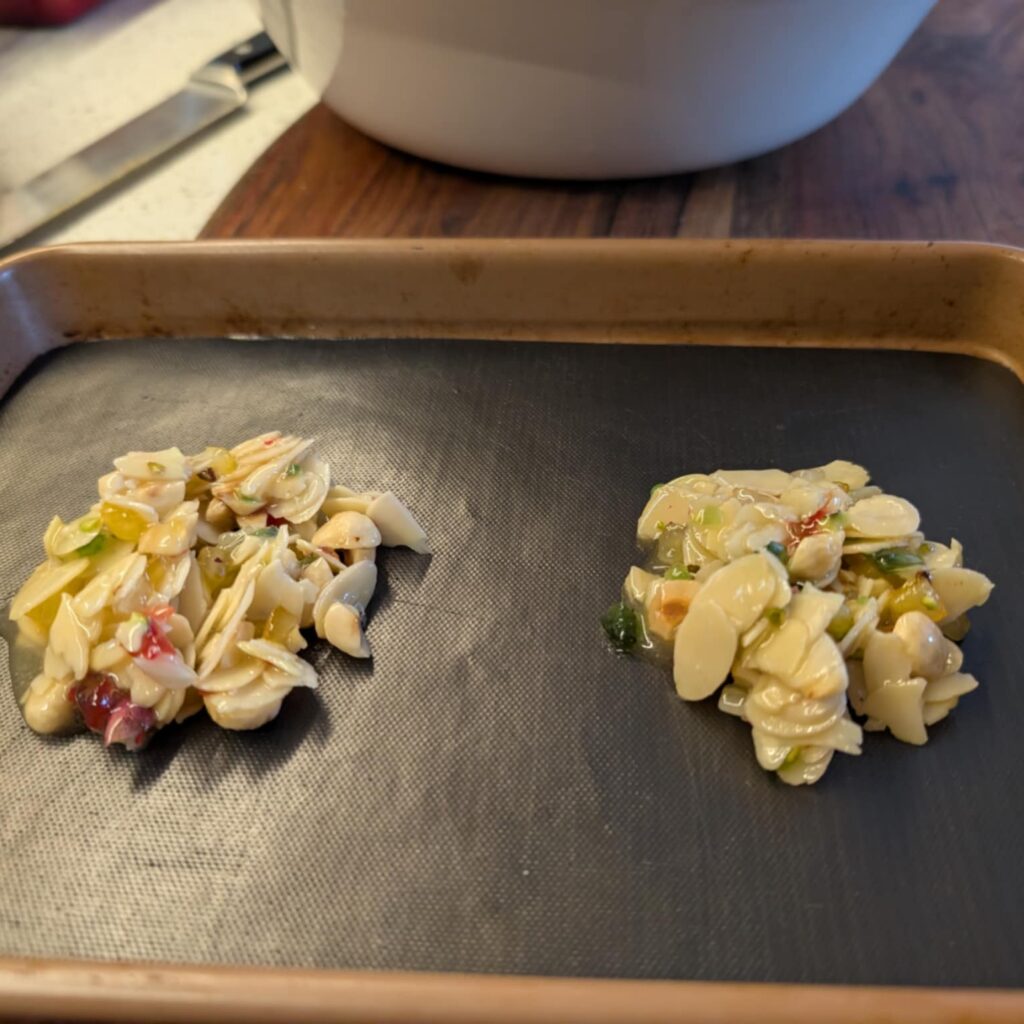 biscuits on a black lined oven tray ready for the oven