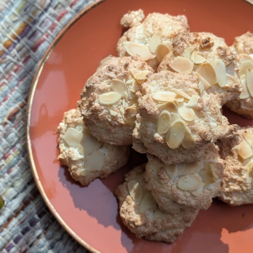 an orange plate piled with brown nut biscuits