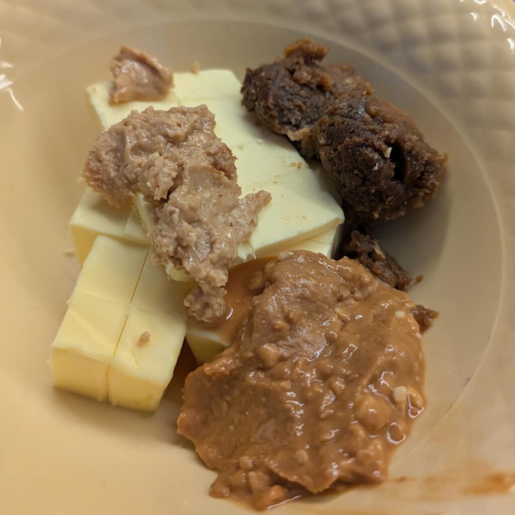 brown pastes and butter in a beige bowl