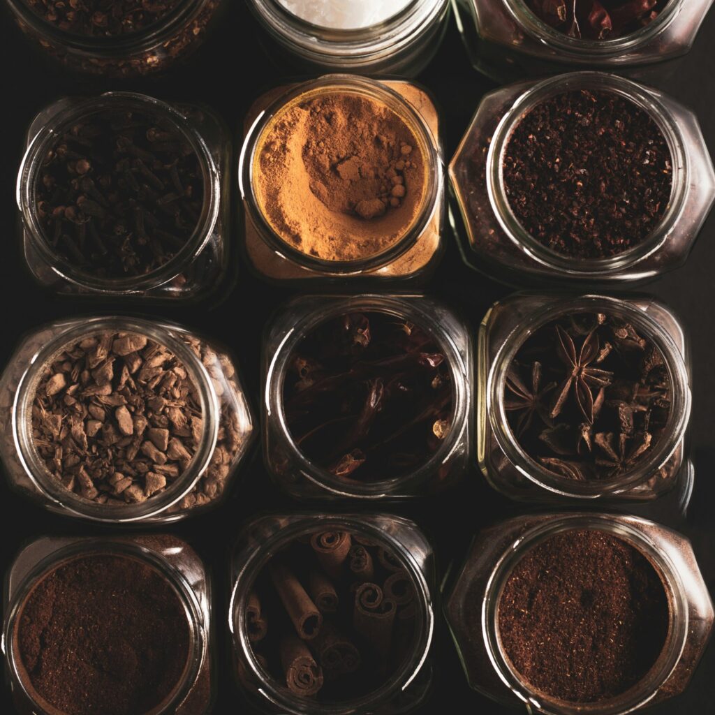 glass jars with different spices whole and ground