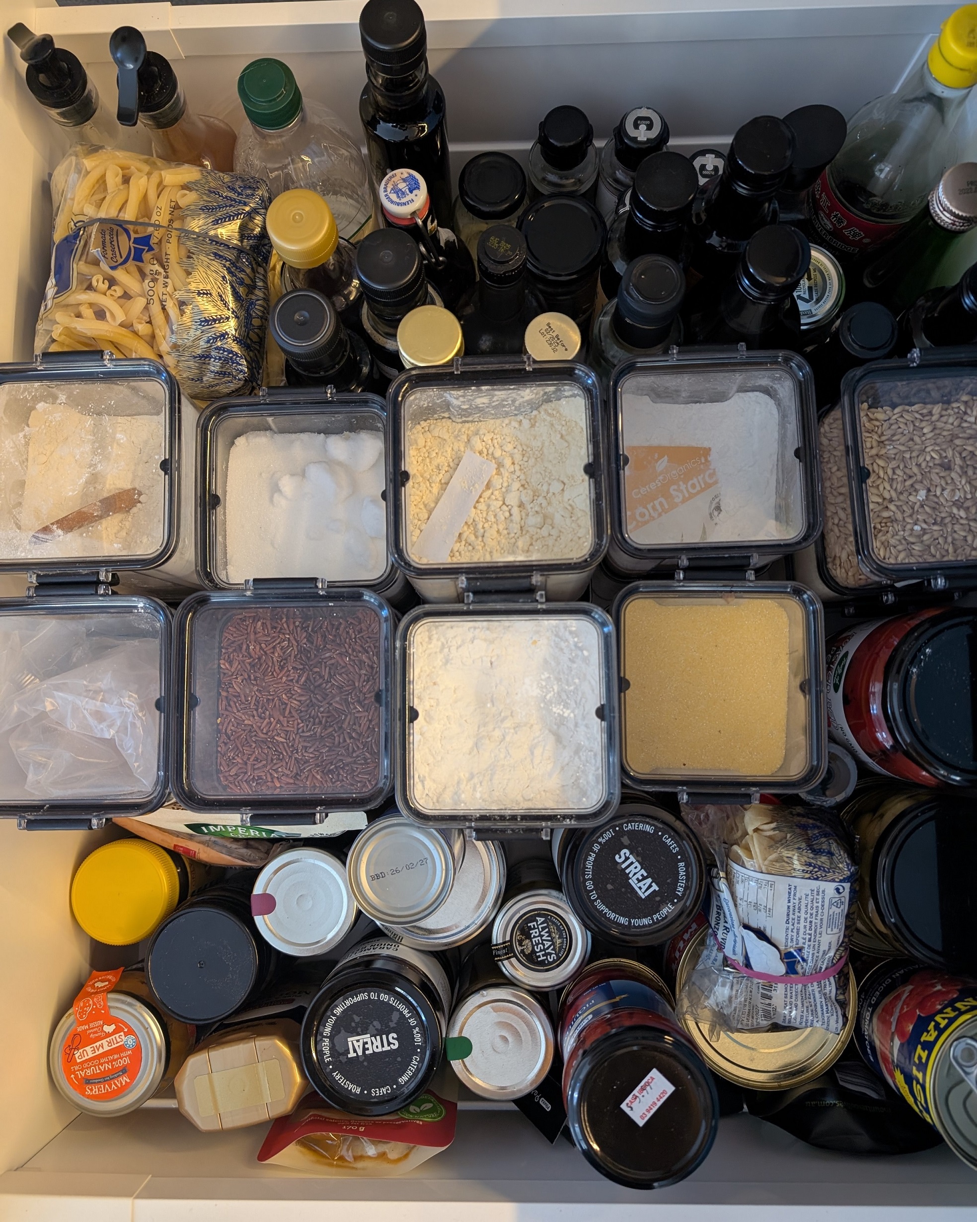 bottle and jars and containers of food in a drawer
