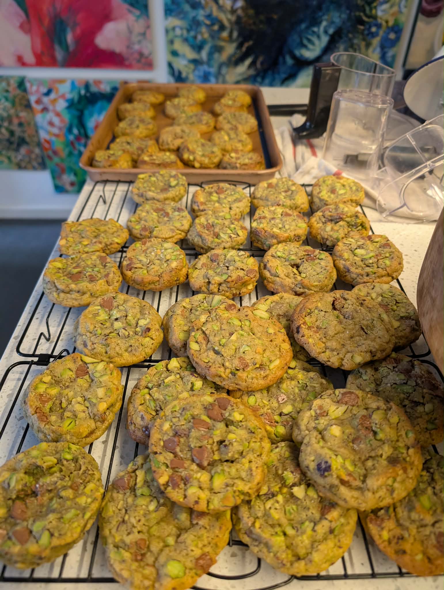 cooling racks of stacks of pistachio chocolate cookies