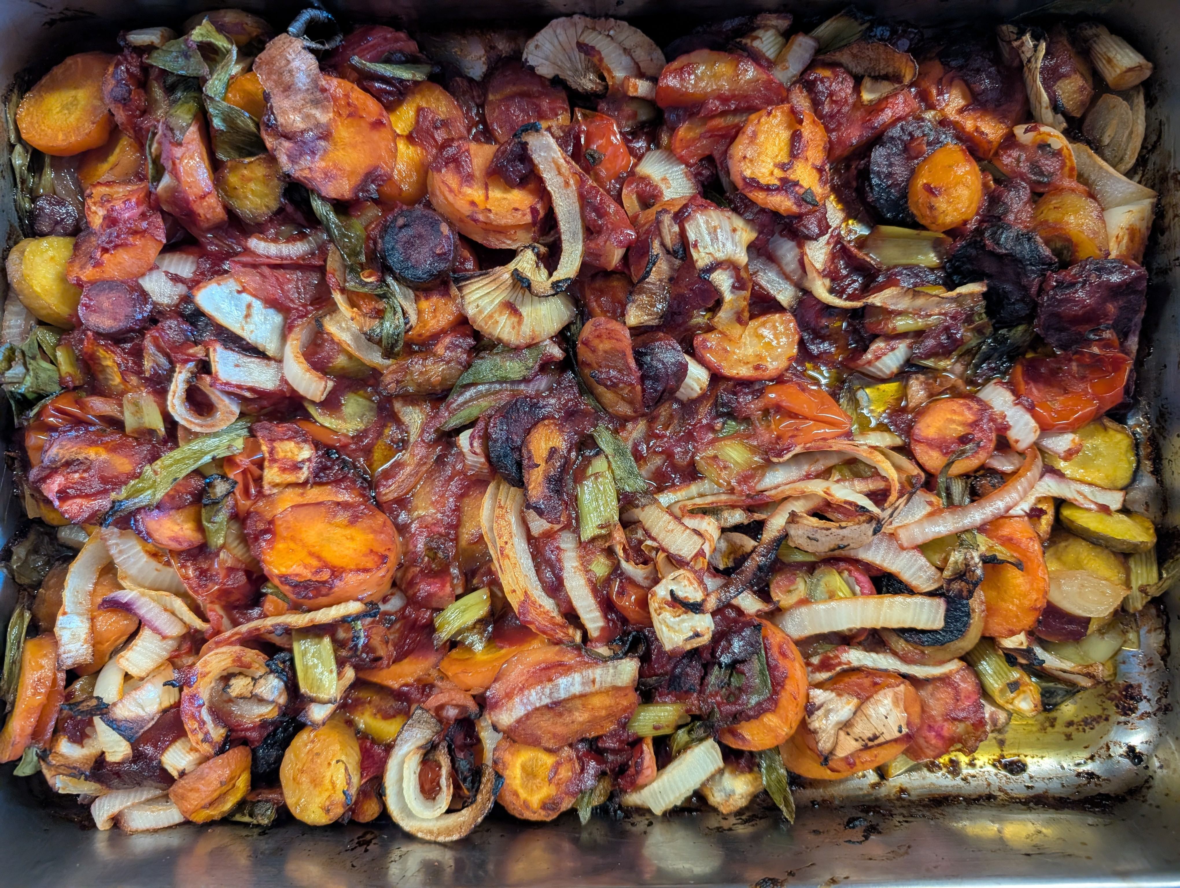 photo of a roasting tin with cooked browned roasted vegetables