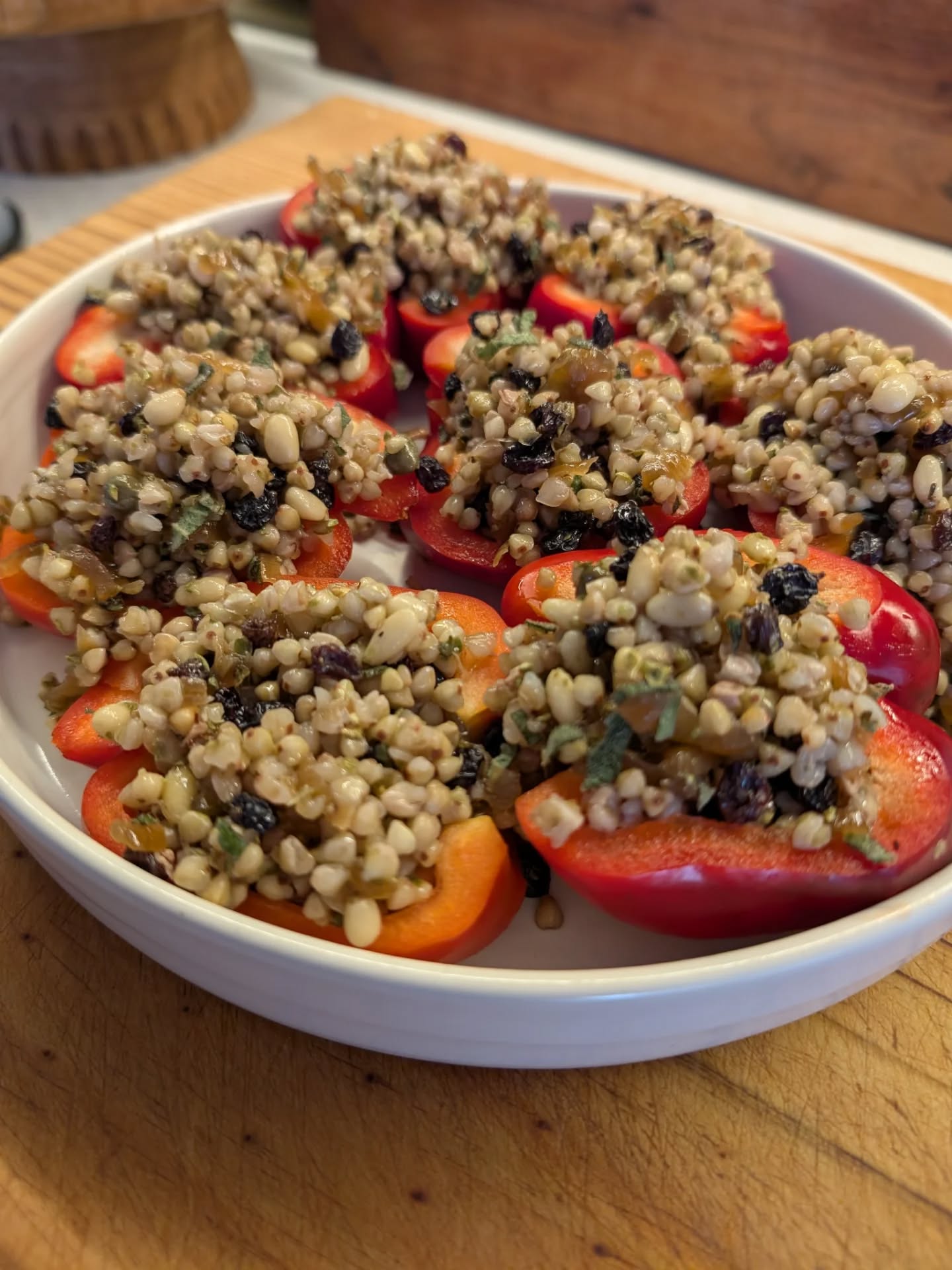 photo of halved red capsicum stuffed with grain and nuts