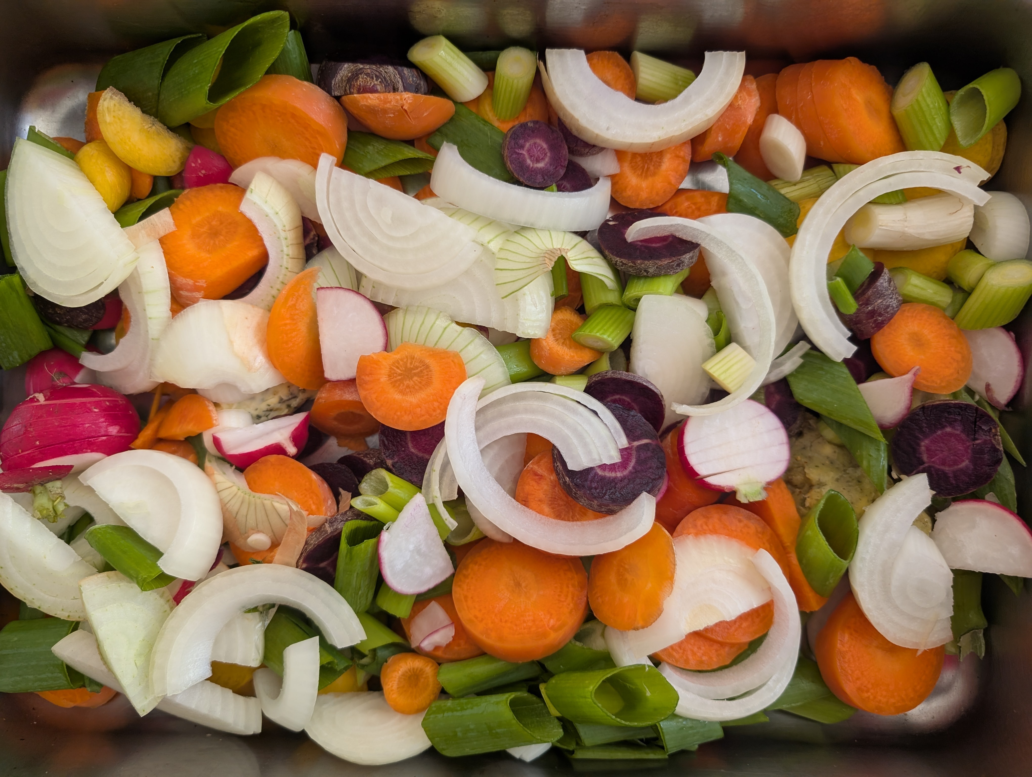 photo of chopped up vegetables in a roasting tin