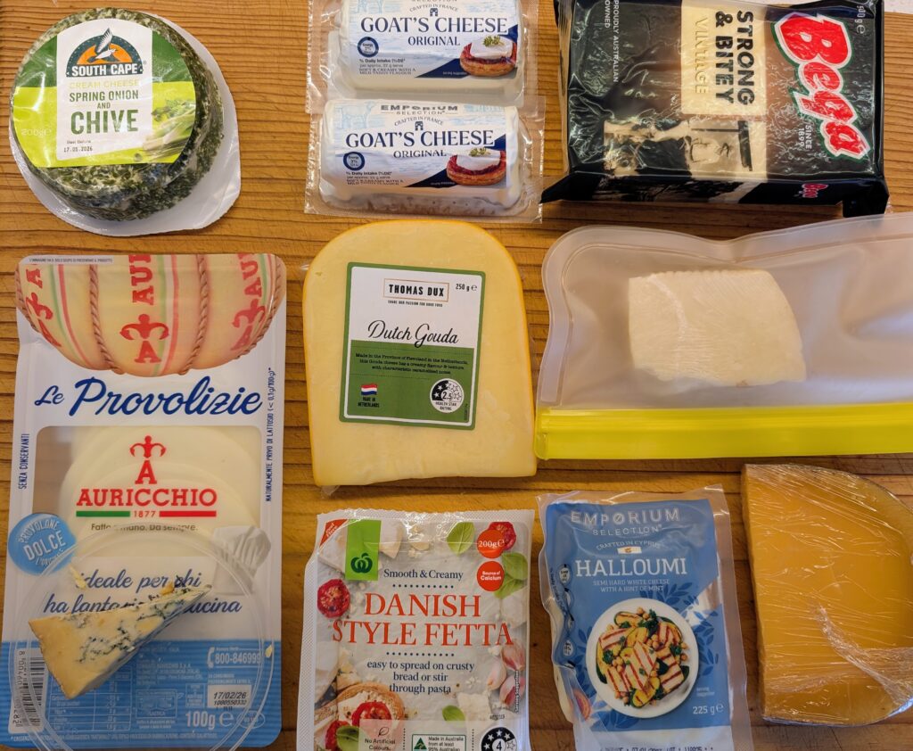 photo of ten packets of cheese laid on a wooden board