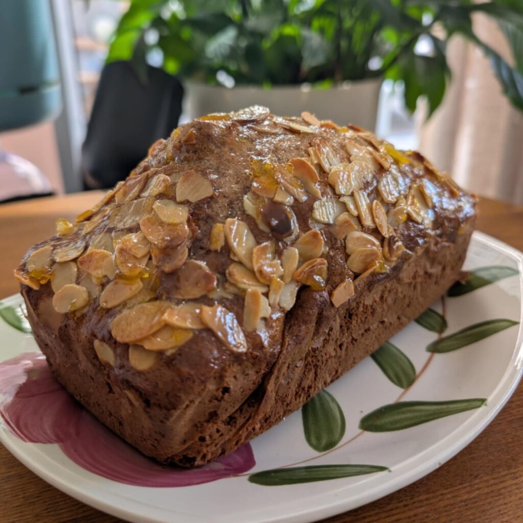 photo of a loaf shape cake topped with nuts